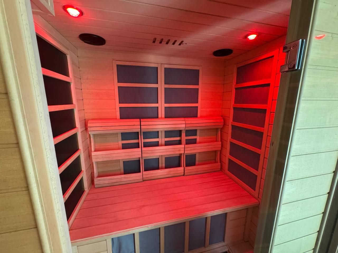 Cedar infrared sauna with warm amber glow and hanging plants